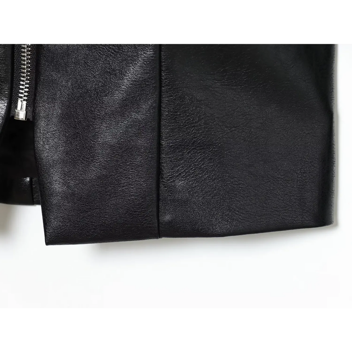 Close-up of black pointed hem detail