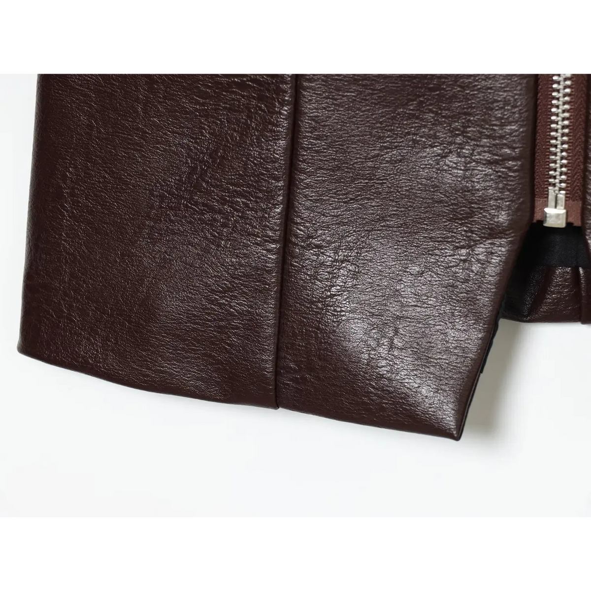 Close-up of brown pointed hem detail