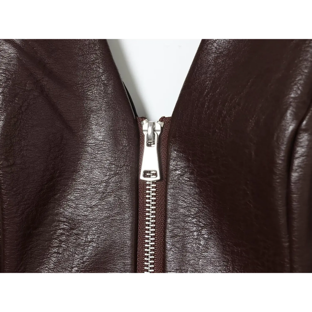 Close-up of brown silver zipper pull