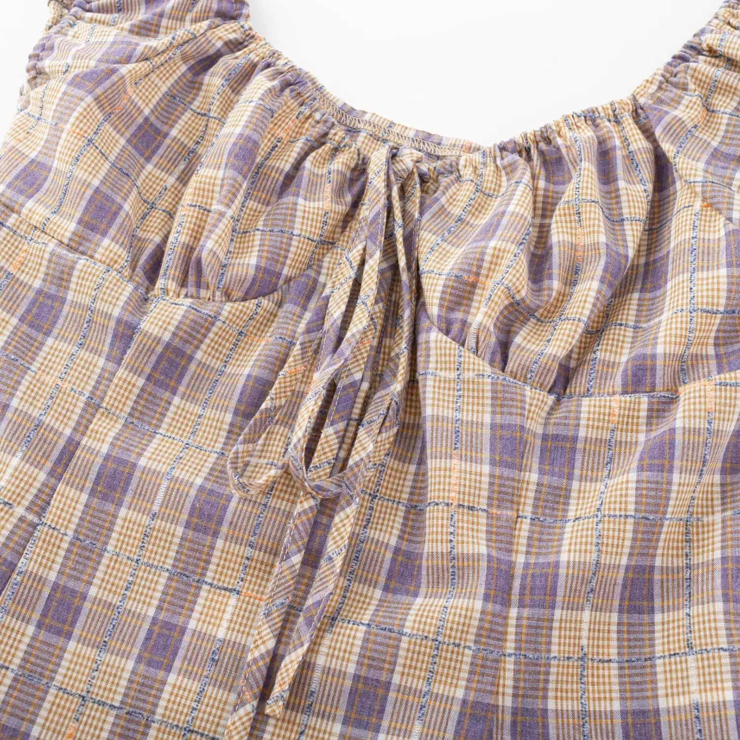 Flannel plaid crop top front tie close-up, natural ruched texture woven plaid fabric stitching flat lay detail