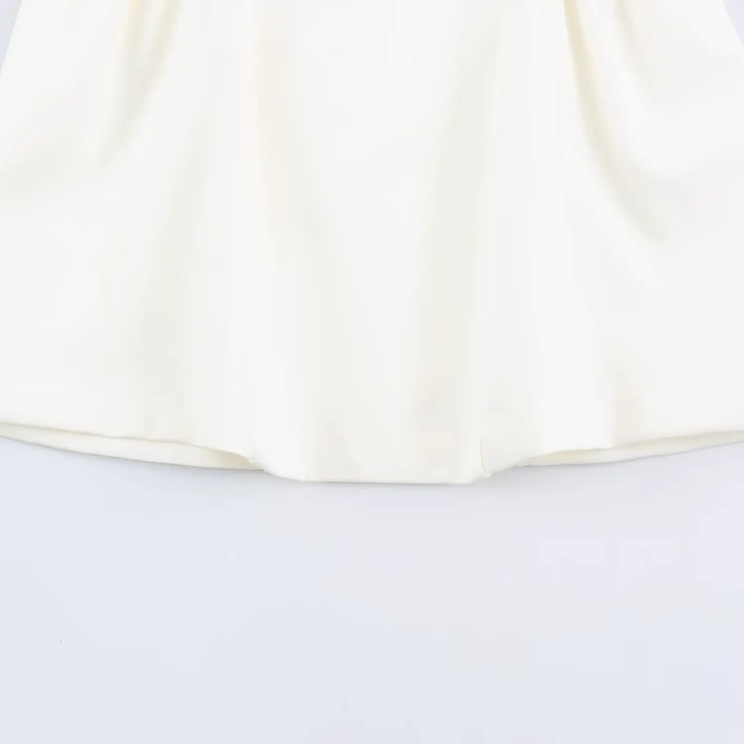 Close-up of neat finished hem on flared mini skirt