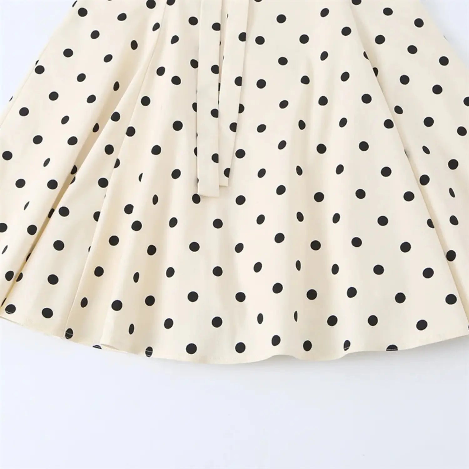 Whole skirt hem partial view, horizontal tier gathering seam, loose swing flared silhouette, uniform bottom hem binding stitching