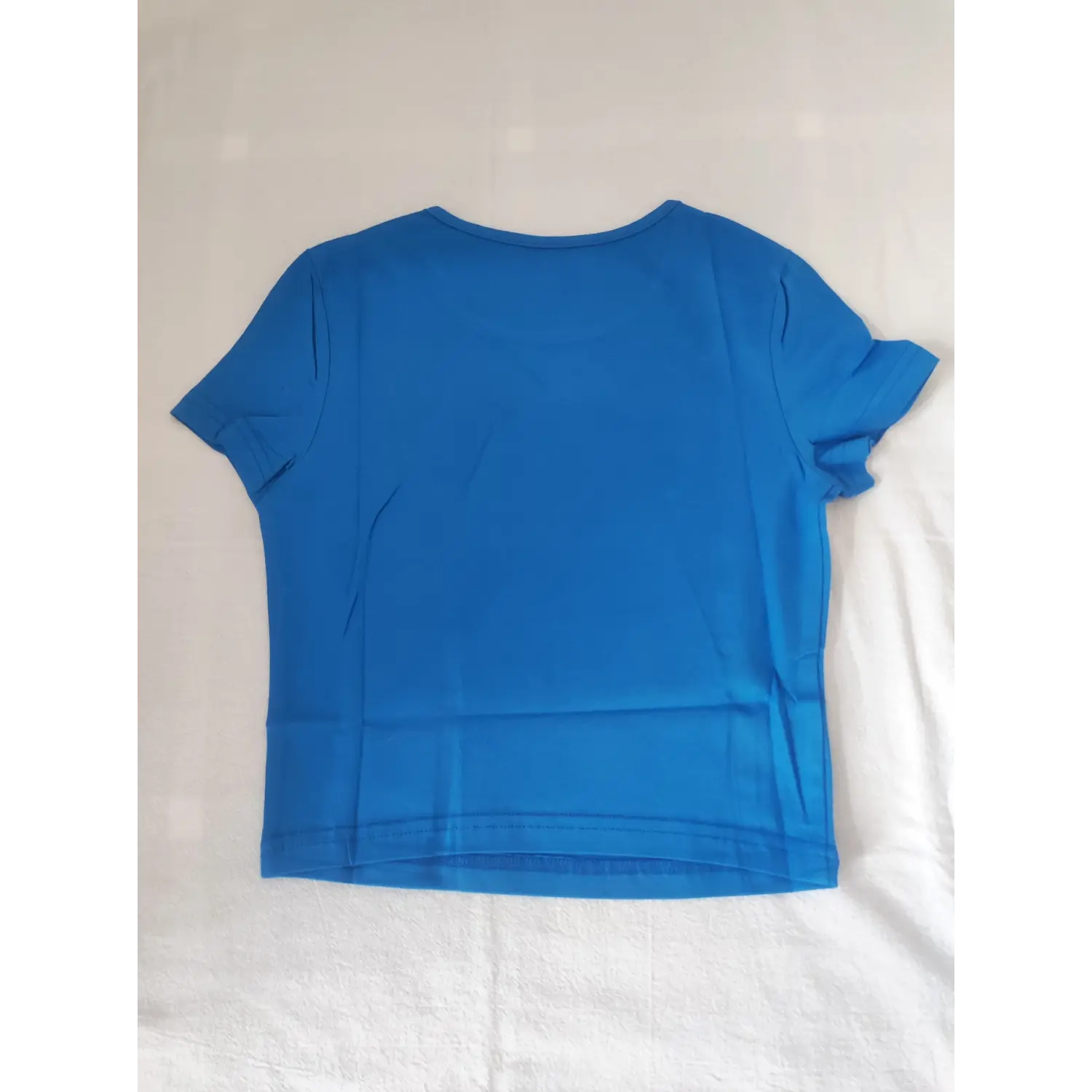 Flat lay back view plain solid blue slim crew neck cropped short sleeve tee