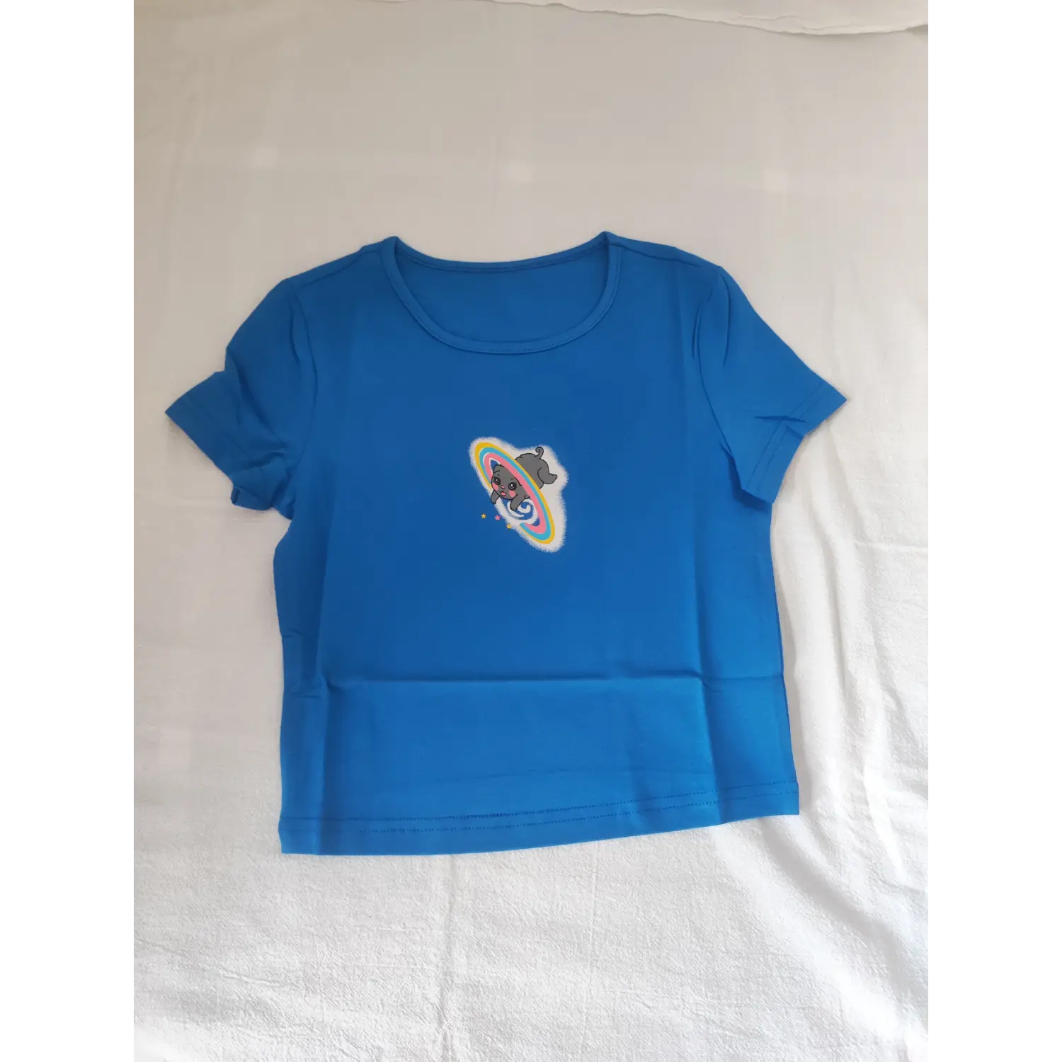 Flat lay front view bright blue fitted crew neck cropped tee featuring cartoon cat planet print