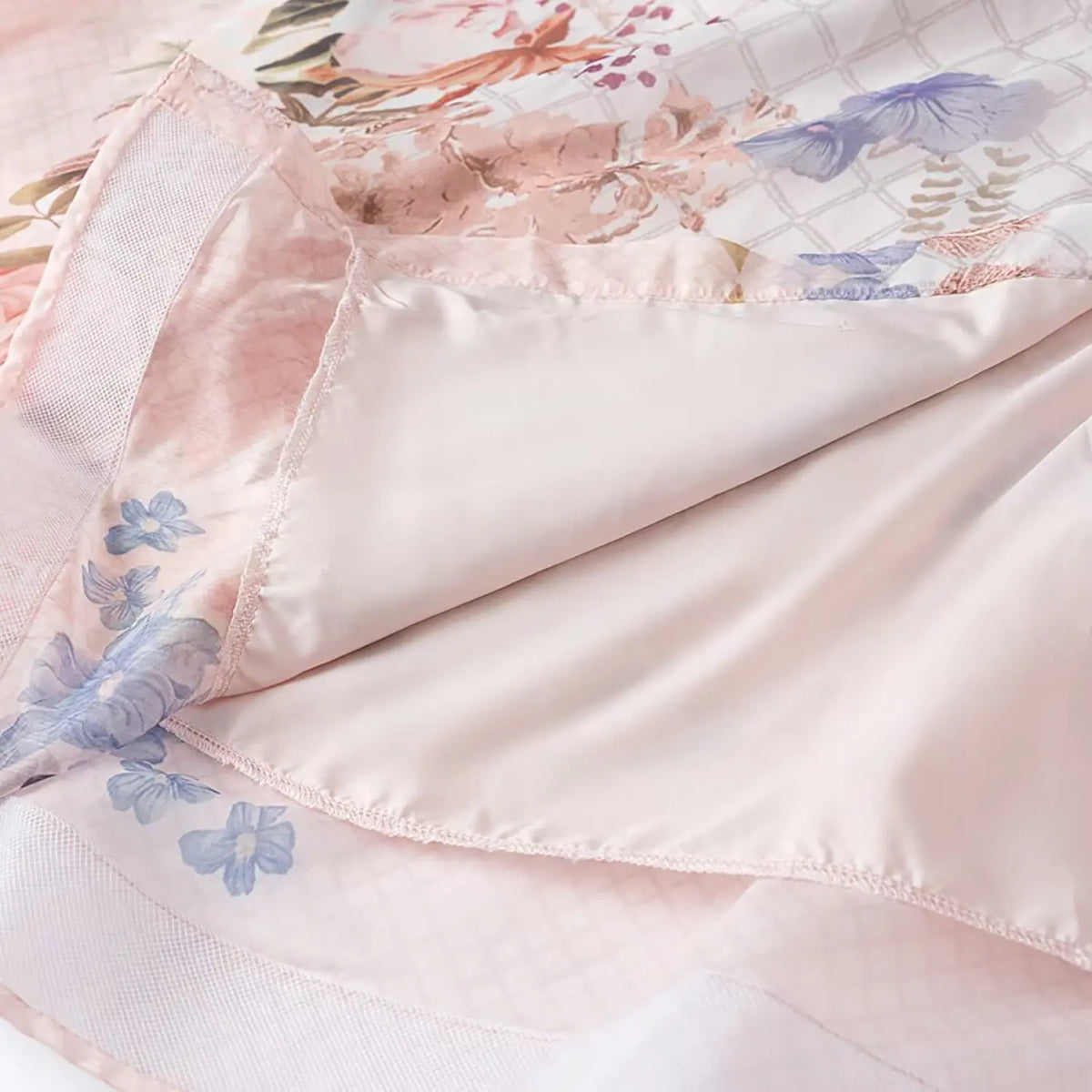 Inner lining shot of floral chiffon maxi dress, soft pink full lining and neat hem stitching