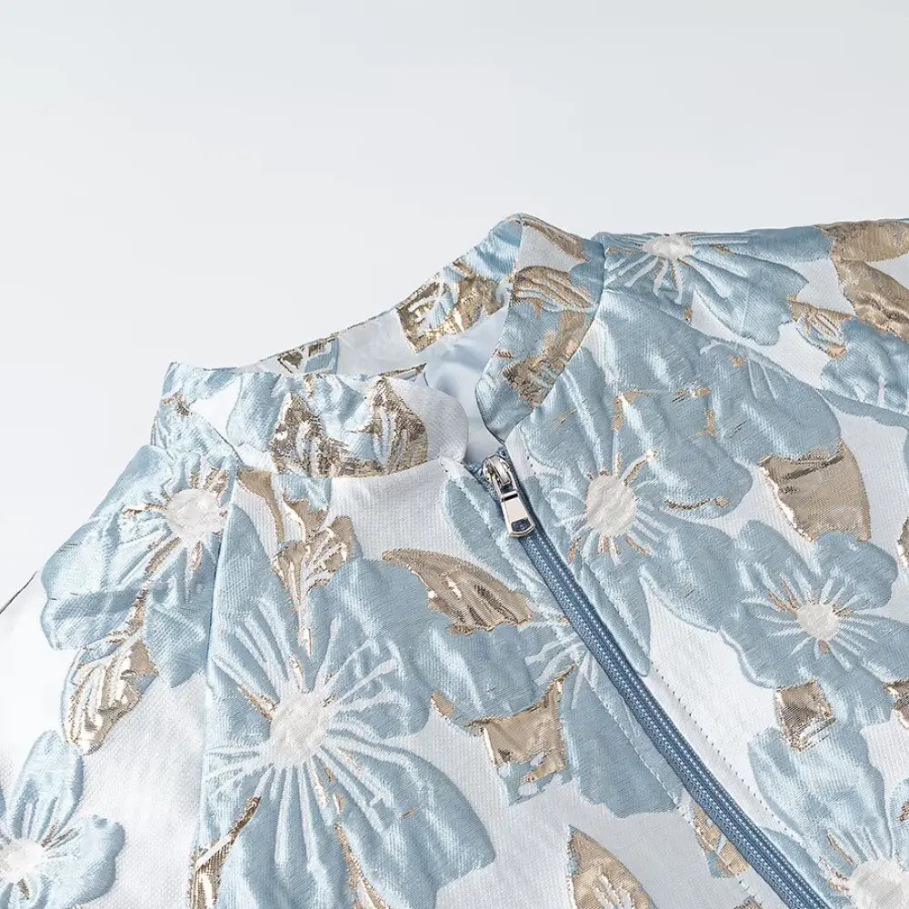 Close-up of stand collar, zipper and gold floral brocade
