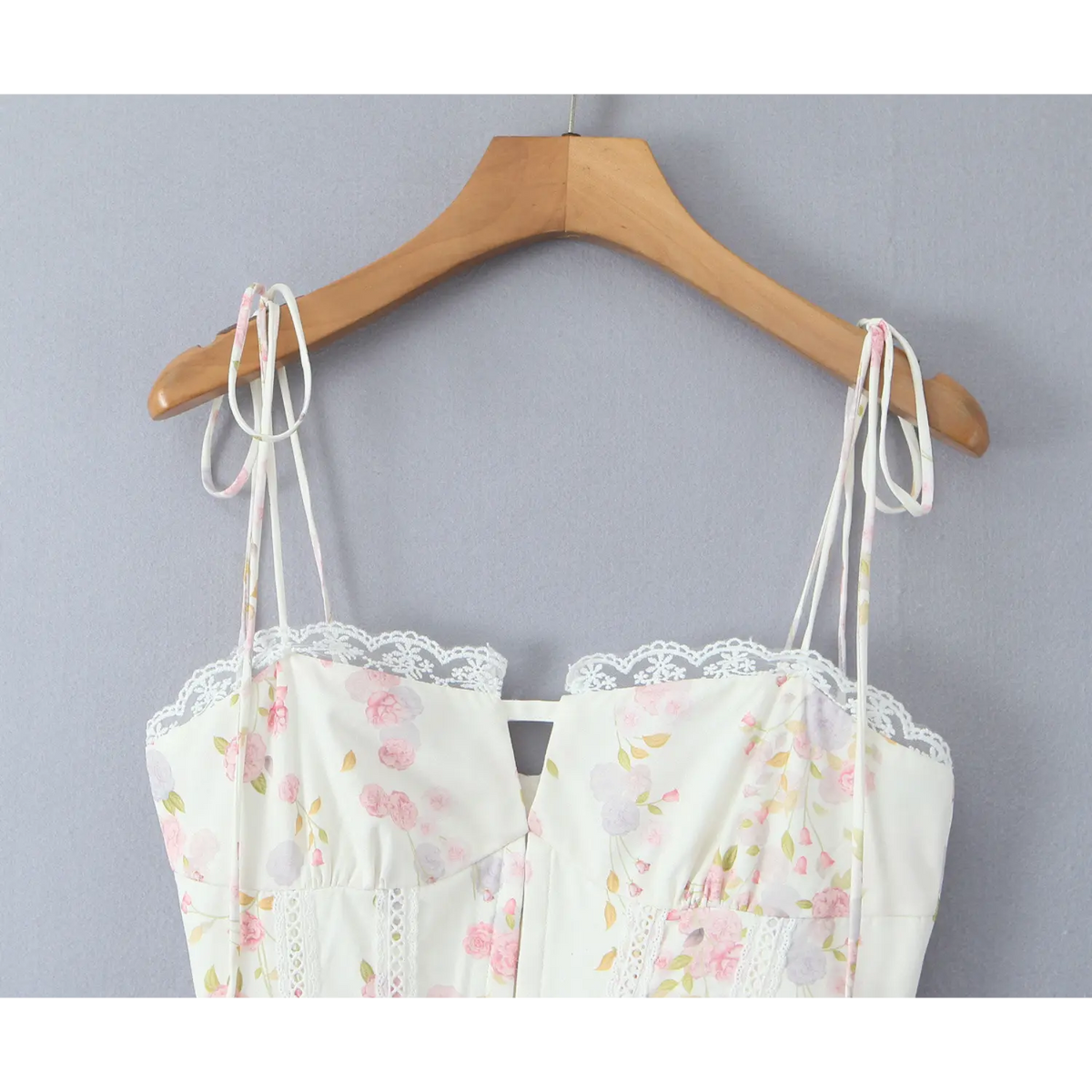 Close‑up of cream floral cami dress, tie spaghetti straps, scalloped lace trim at neckline