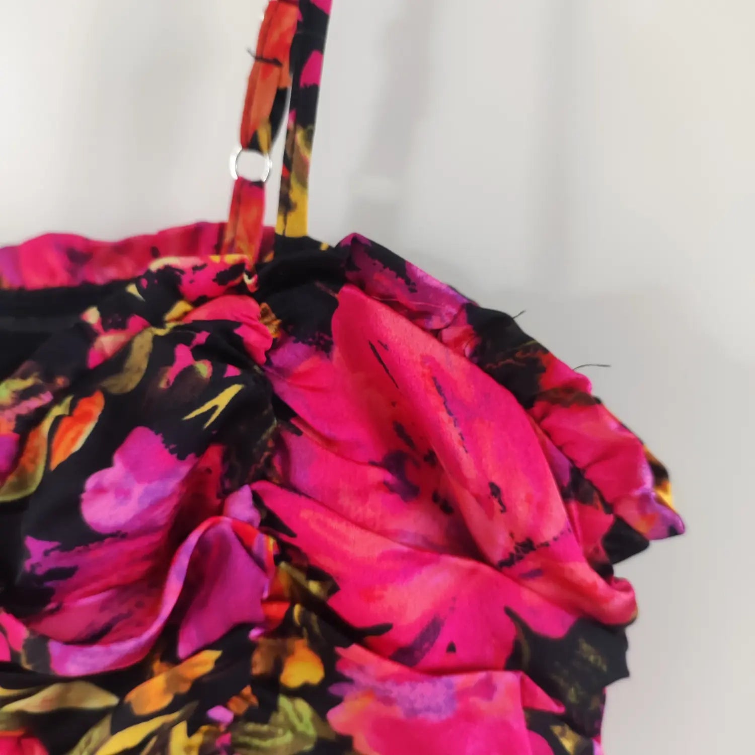 Close‑up adjustable metal slider strap and bust ruffle detail bright floral ruched mini dress