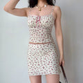 The cream rose-print two-piece set styled with a brown crocodile-pattern handbag.
