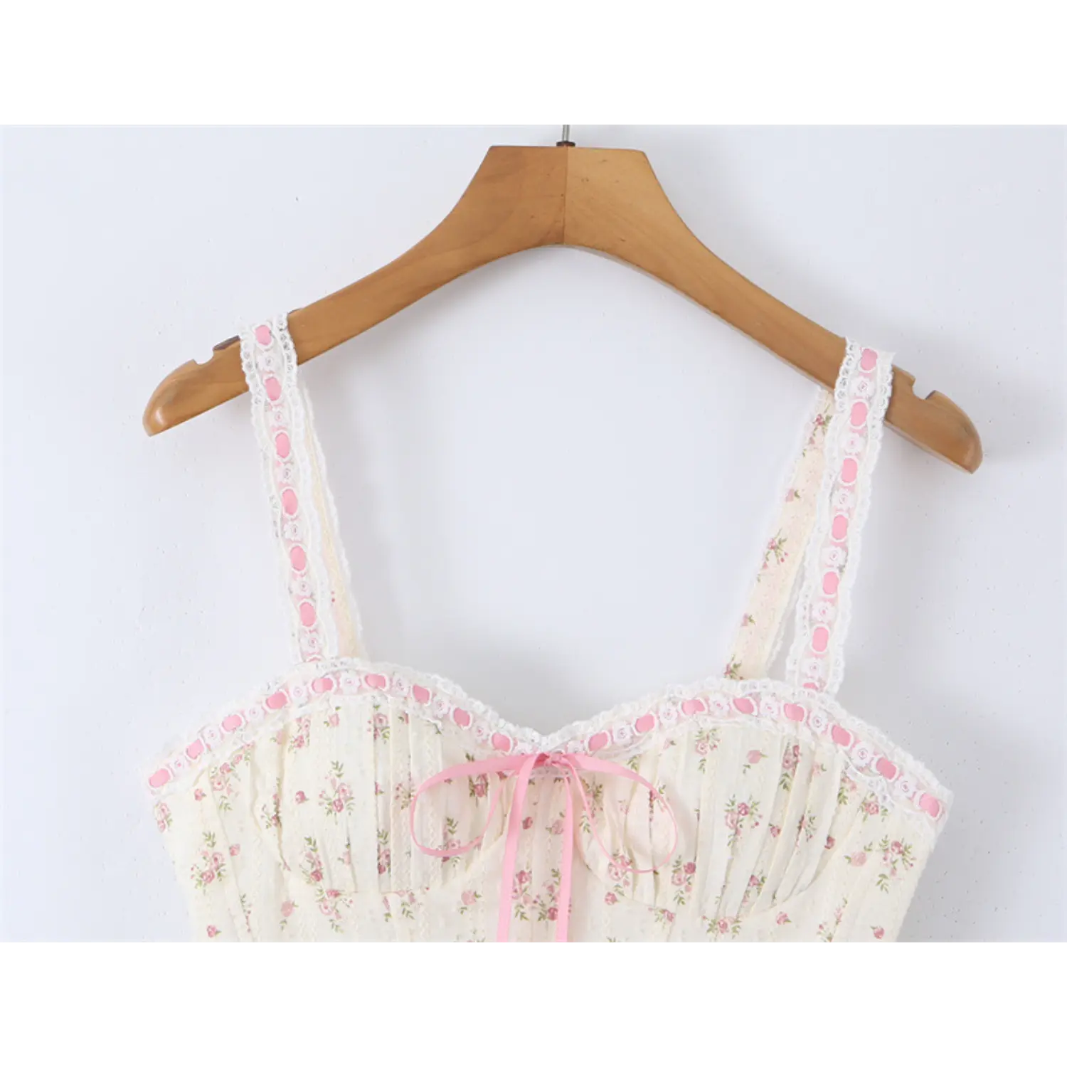 Full front view of the floral print corset-style camisole top on a wooden hanger