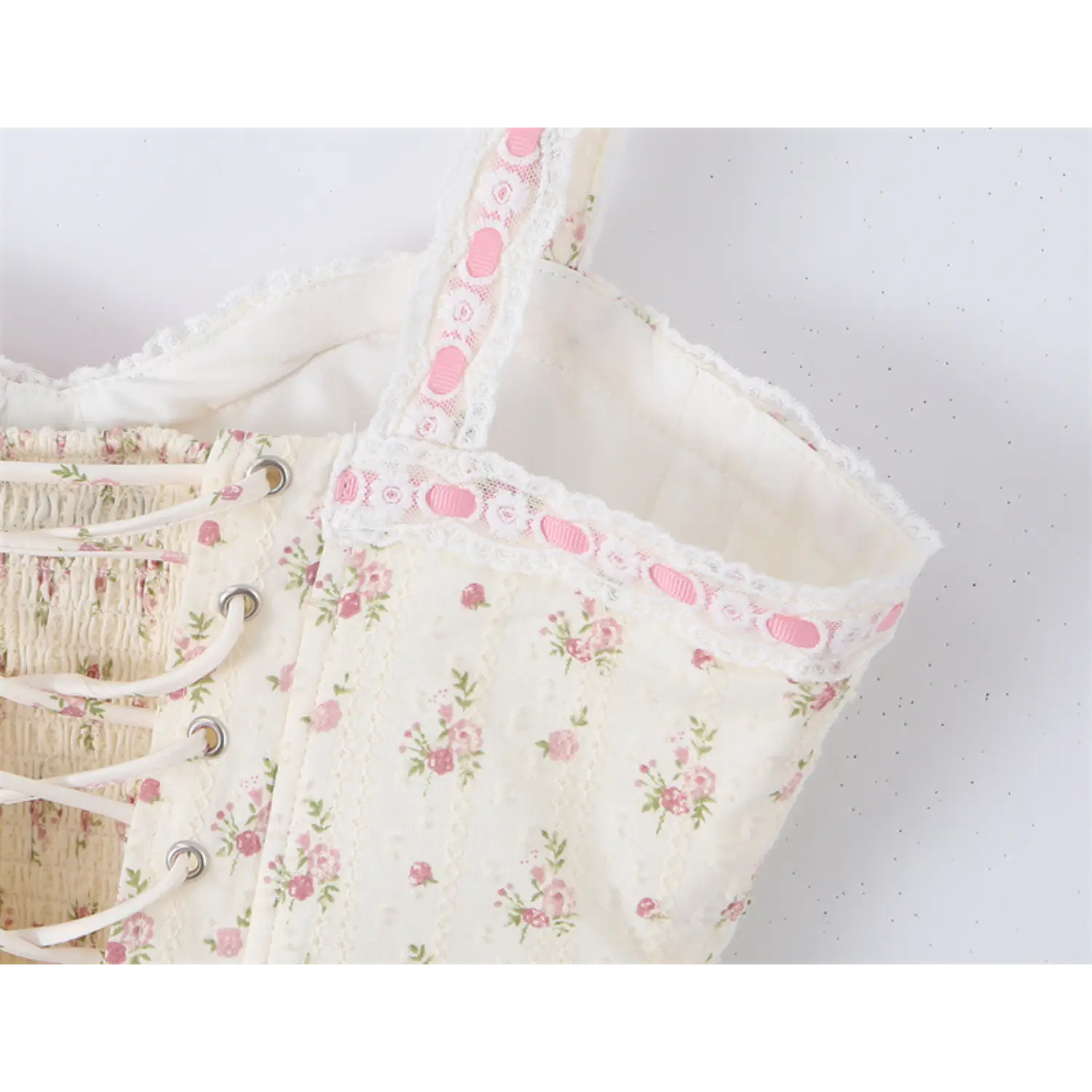 Close-up of the side invisible zipper closure on the floral print corset-style camisole top