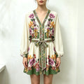 Model wearing floral cherry print V neck belted long sleeve mini dress