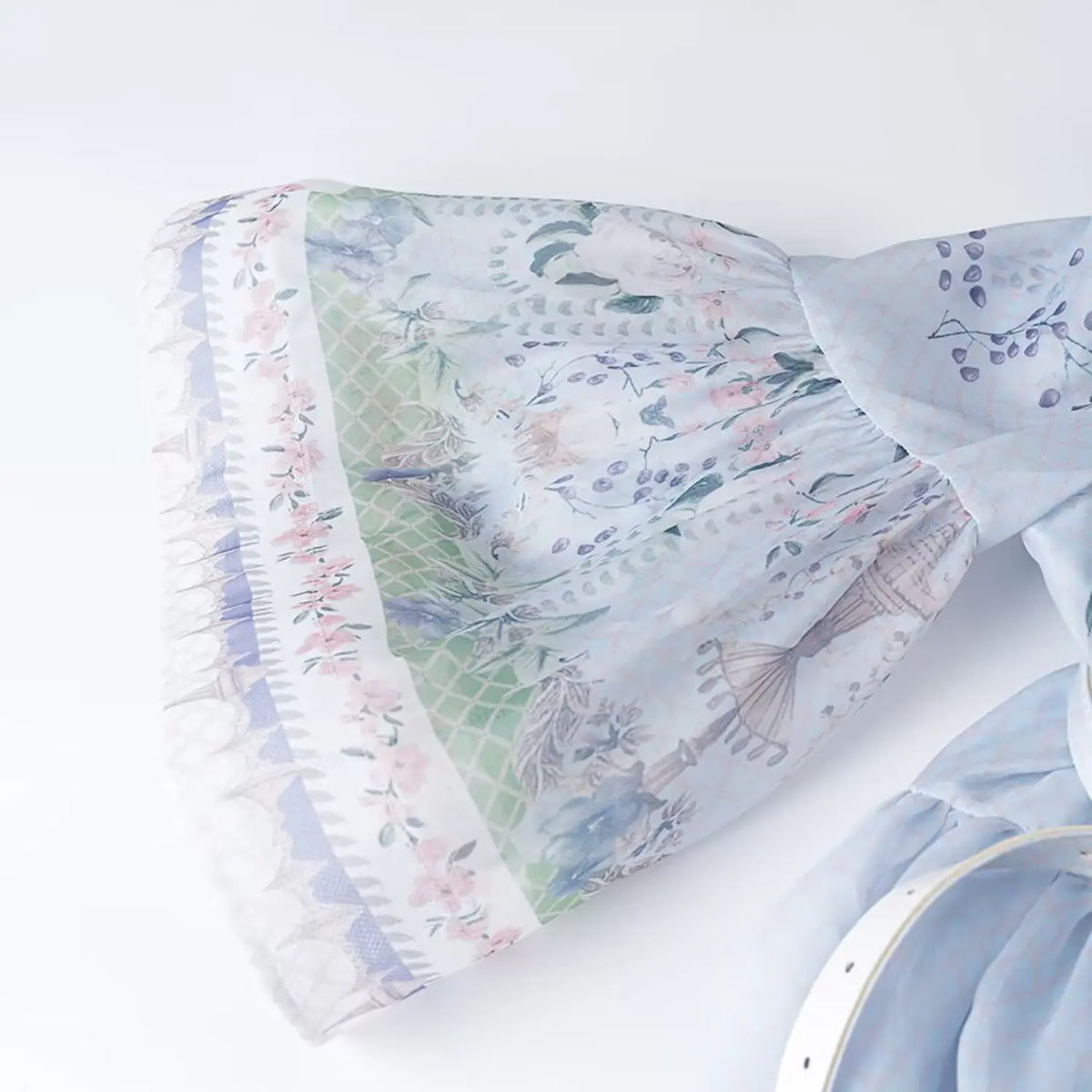 Close-up of flared bell sleeve cuff with border print for floral parrot chiffon maxi dress