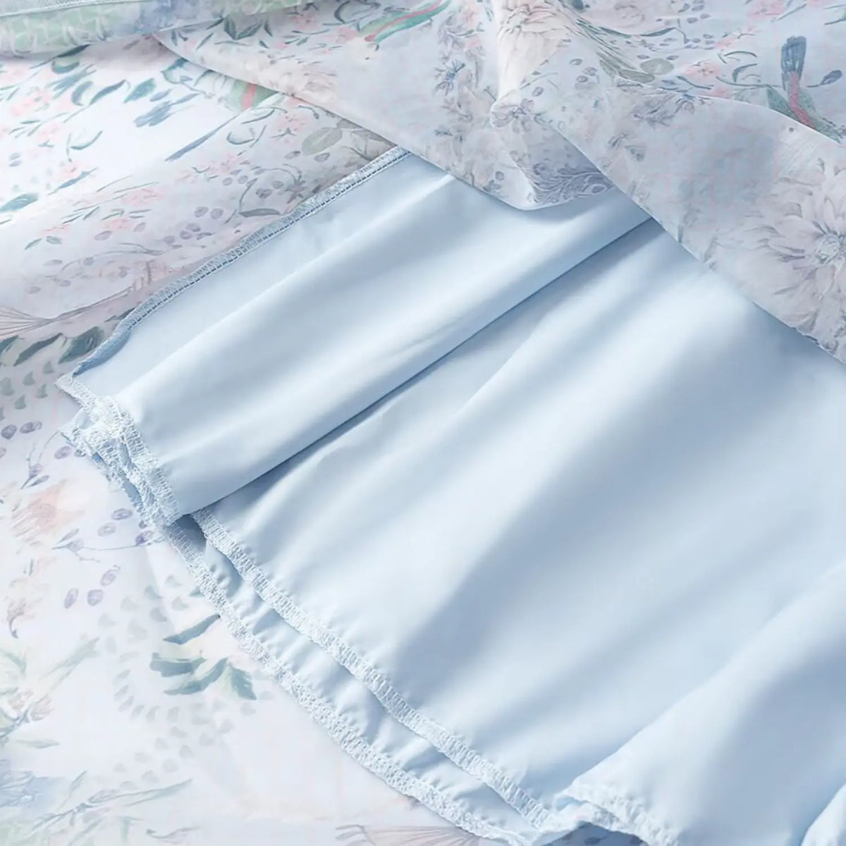 Inner lining closeup of floral parrot print maxi dress, soft light blue full lining with neat stitching