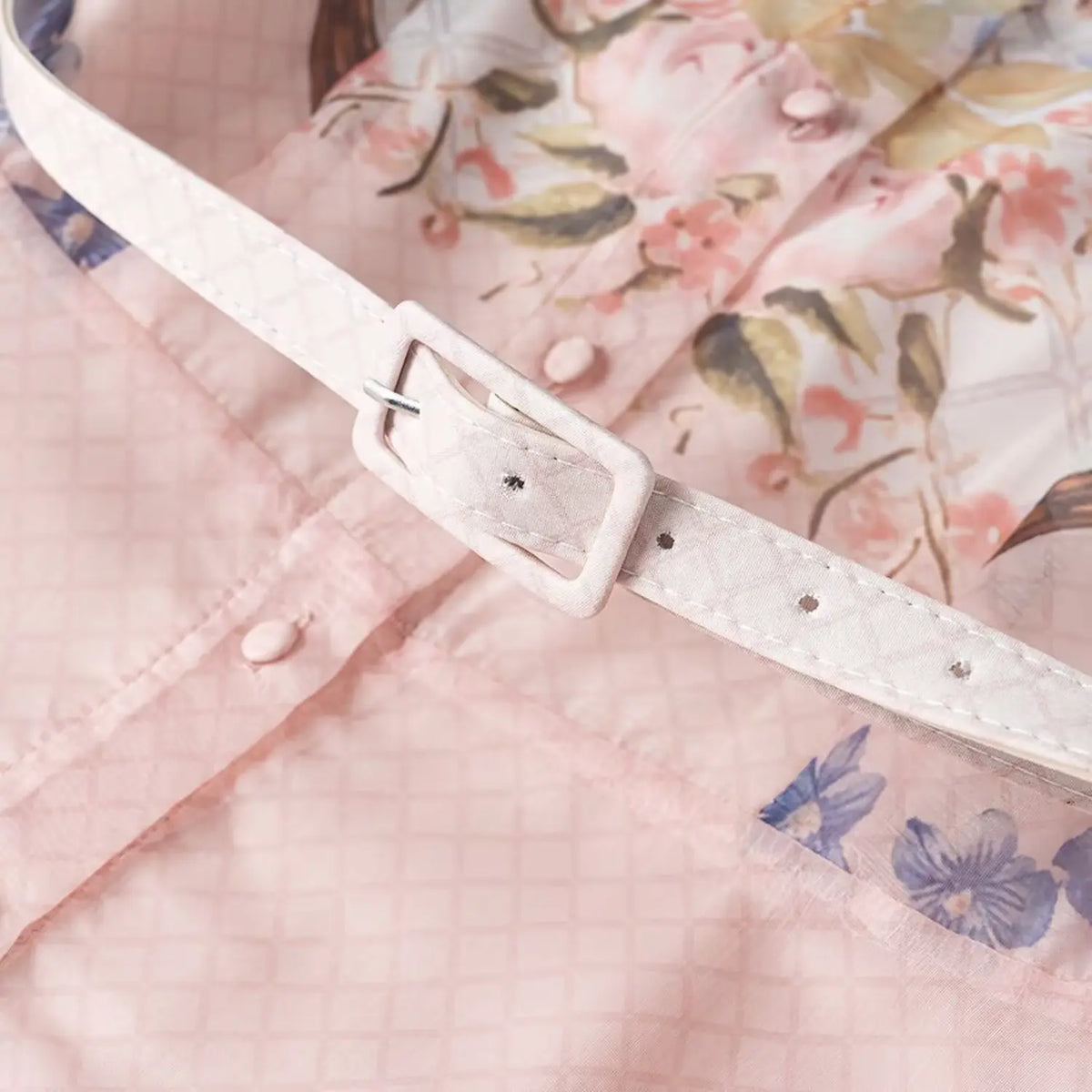Close-up of matching textured waist belt with square buckle for floral chiffon maxi dress