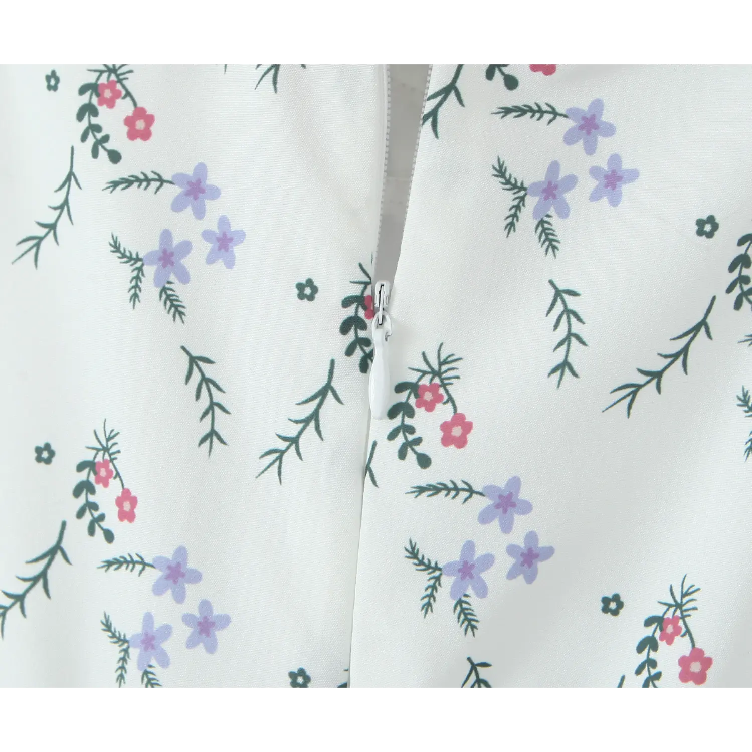 Close‑up invisible back zipper detail, white fabric with purple and red ditsy wildflower print