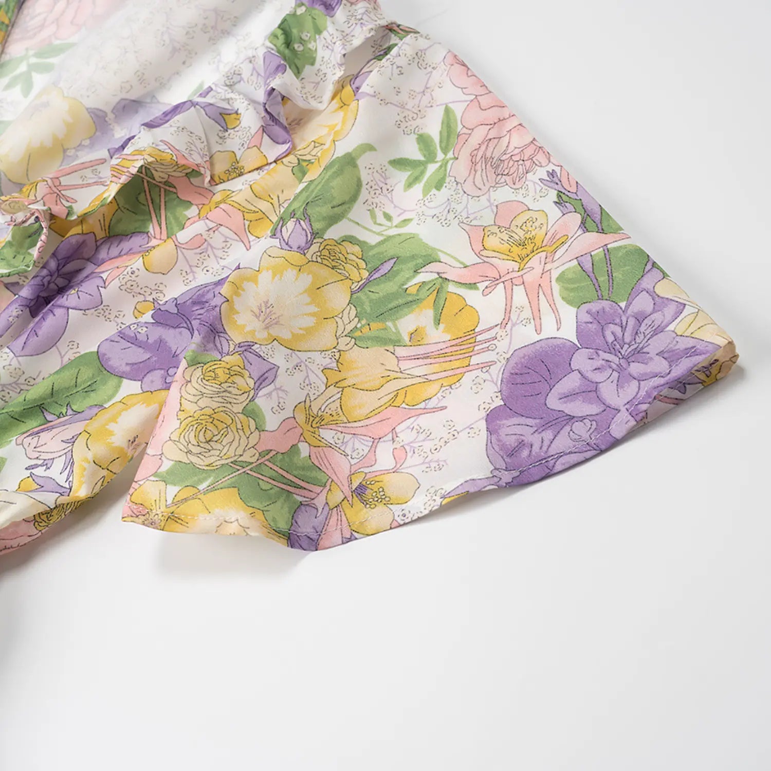 Short sleeve detail of white base vintage floral mini dress with purple pink yellow flower pattern