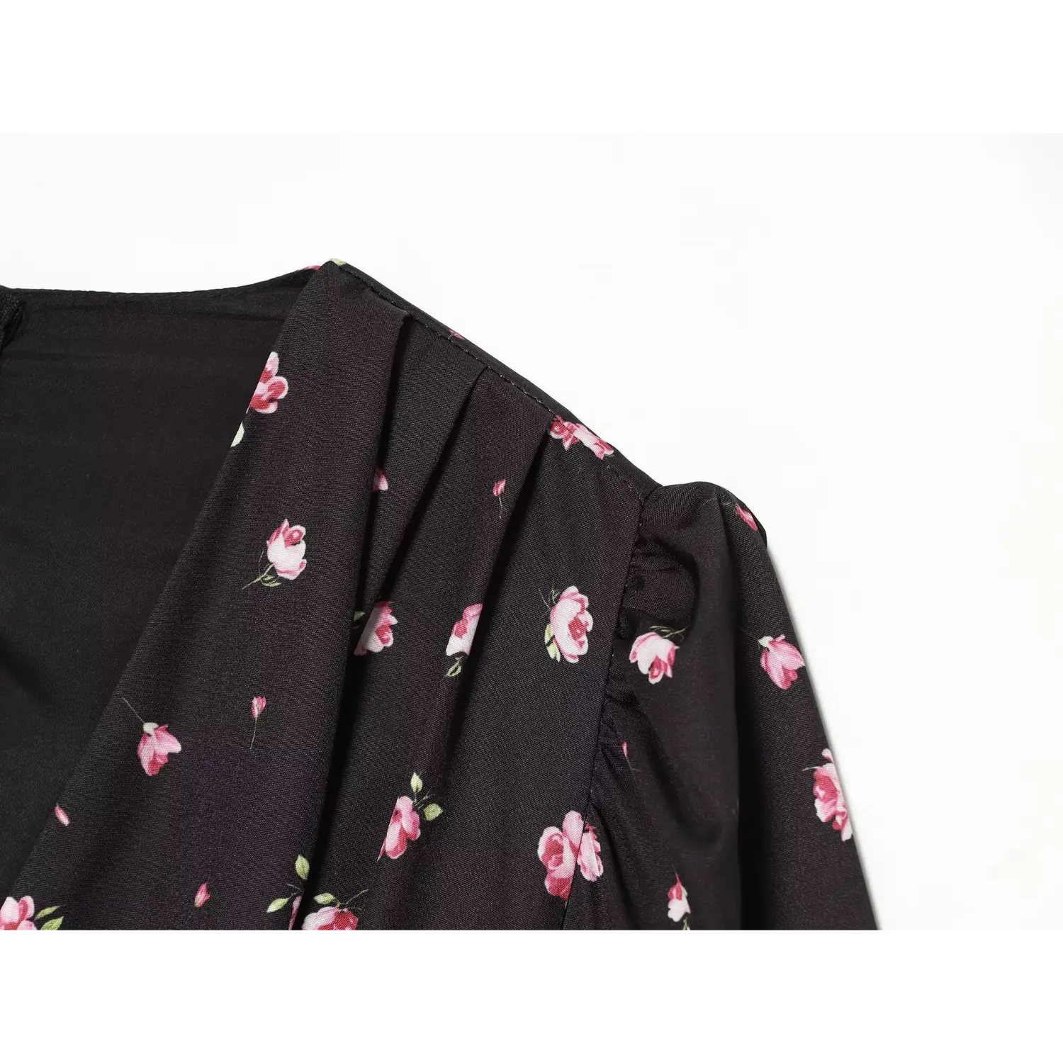 Close-up shoulder pleats and puff sleeve construction on black pink ditsy rose dress