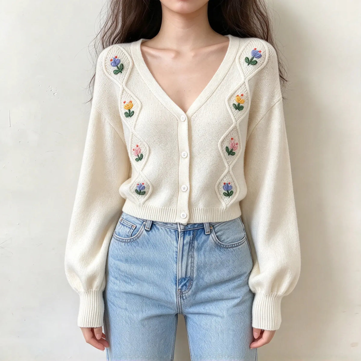 Model wearing cream floral embroidered diamond knit cardigan, front view