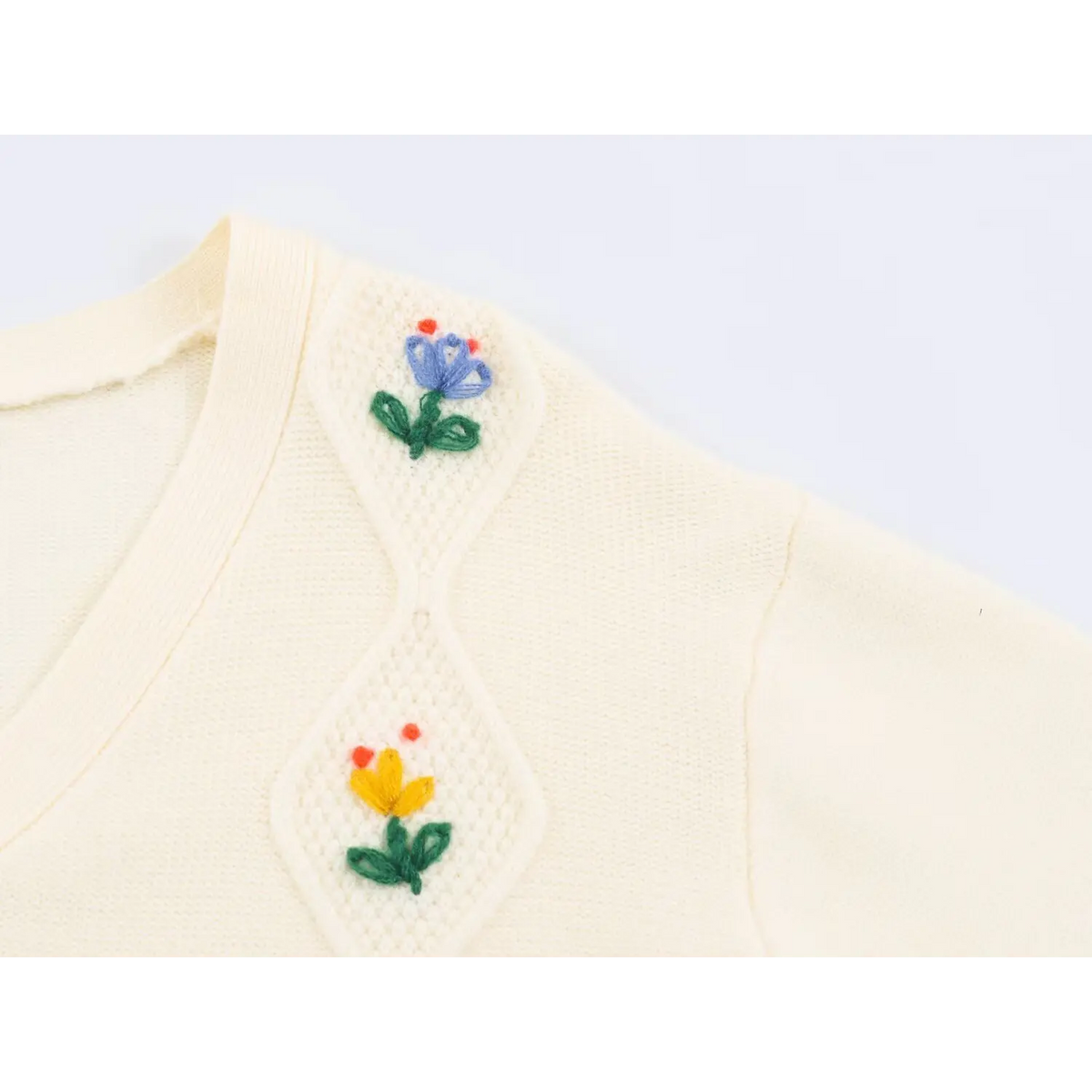 Close-up of shoulder diamond panel and tulip embroidery