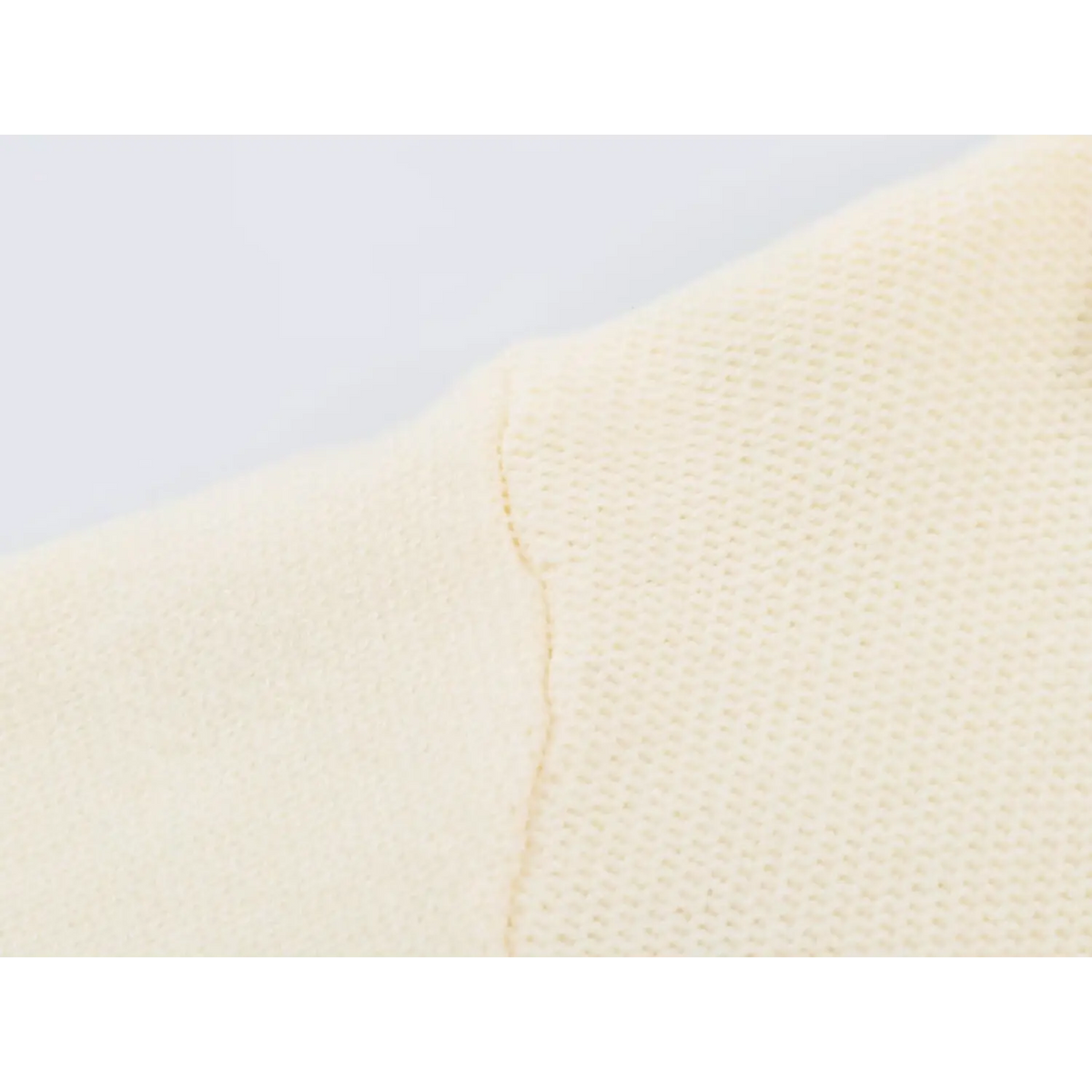 Close-up of knit stitch and shoulder seam detail