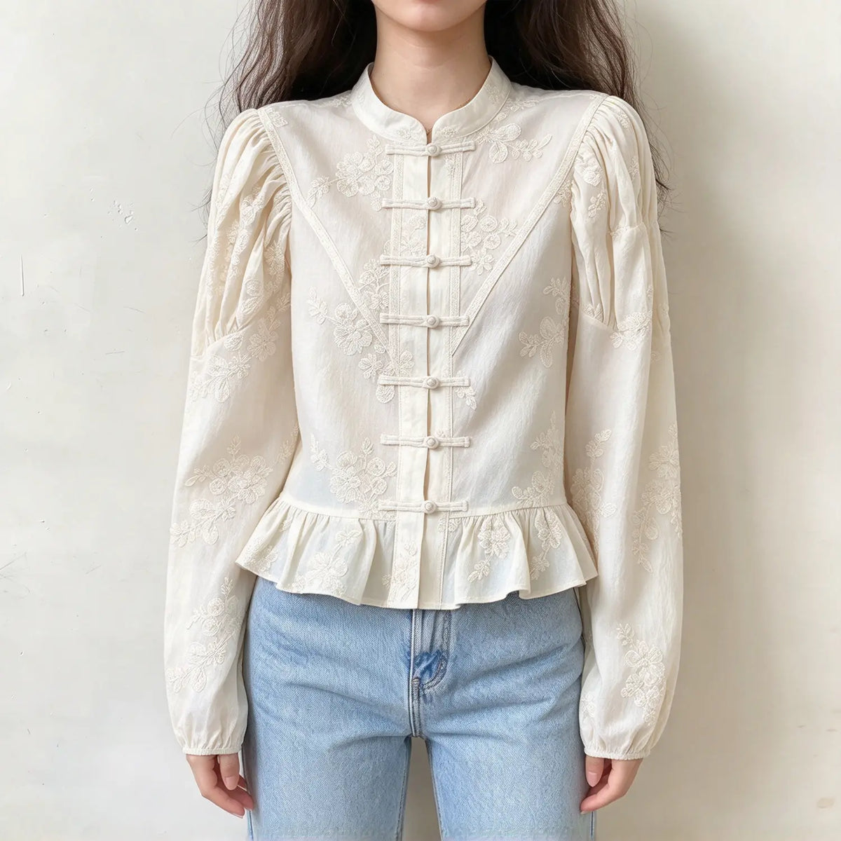 Model wearing ivory floral embroidered frog button stand collar blouse, front view