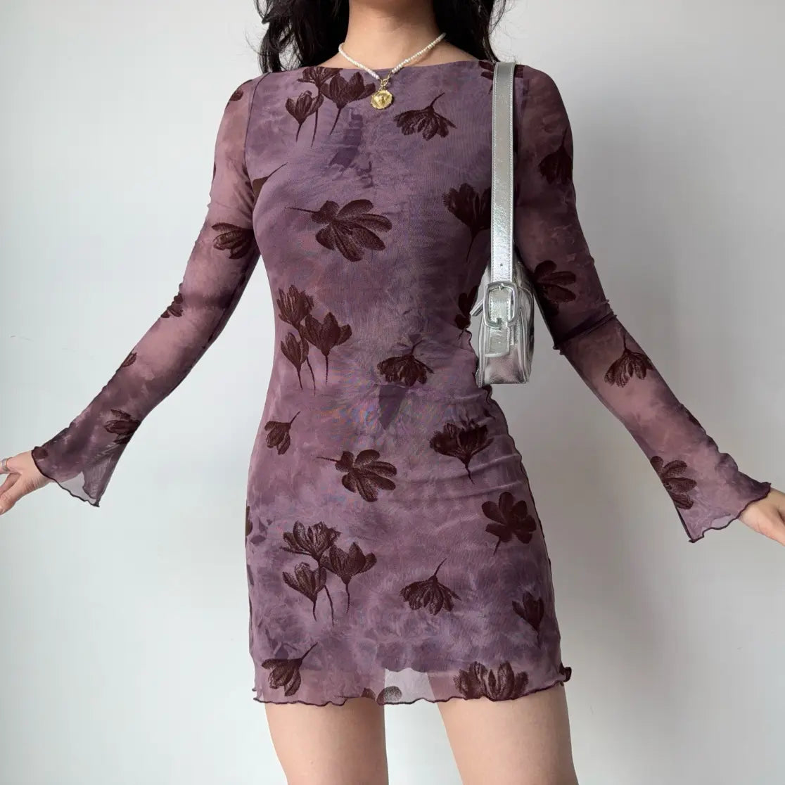 Model wearing floral flocked boat neck long sleeve bodycon mini dress, arms extended view