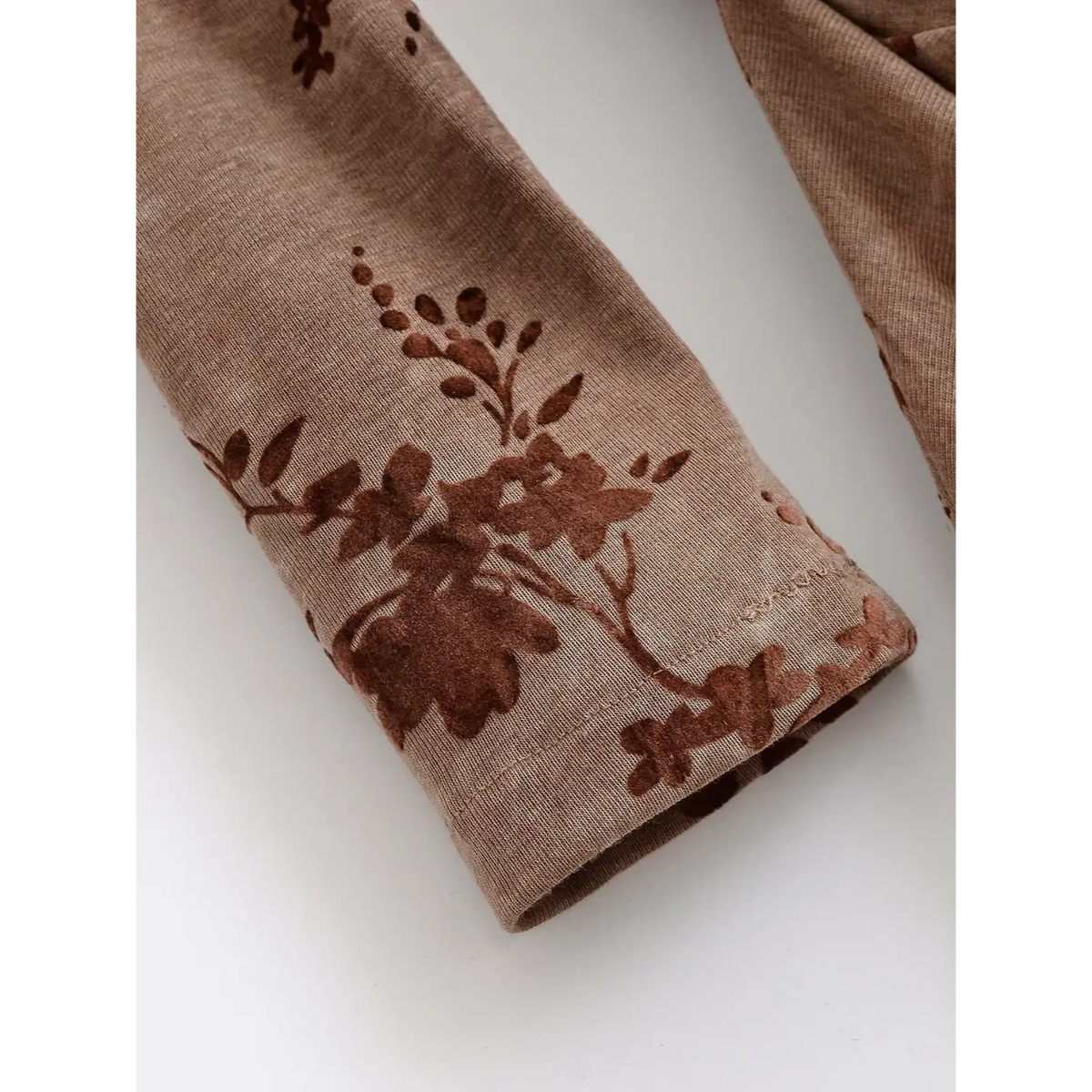 Close-up of long sleeve cuff and flocked floral