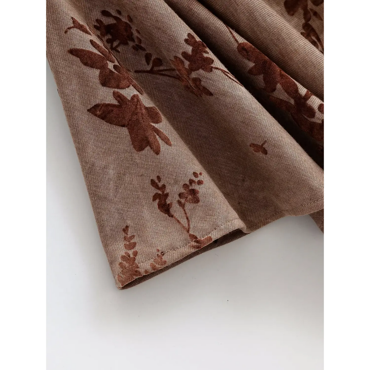 Close-up of dress hem edge and floral print