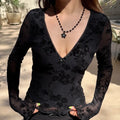 Model wearing floral flocked v neck bow mesh long sleeve top, outdoor close-up view