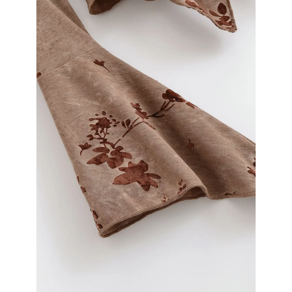 Close-up of flared bell cuff and flocked floral