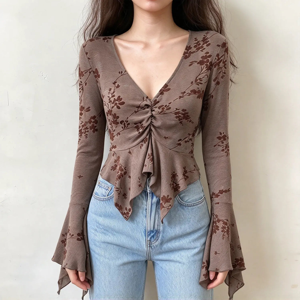 Model wearing mocha floral flocked V neck ruched bell sleeve top, front view