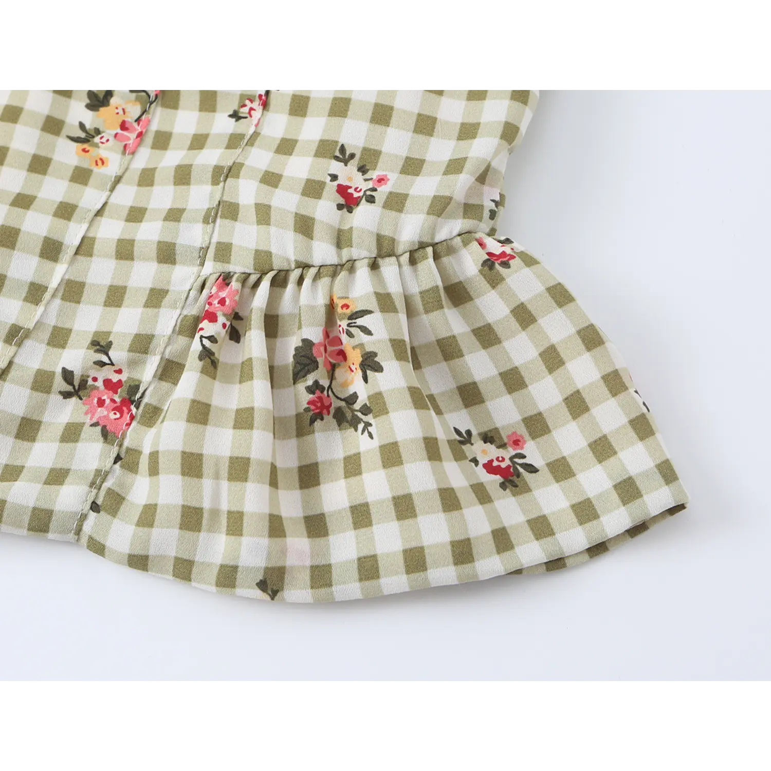 Close up flared peplum ruffle hem detail olive gingham floral camisole, gathered waist design, soft ruffle edge, small rose floral print