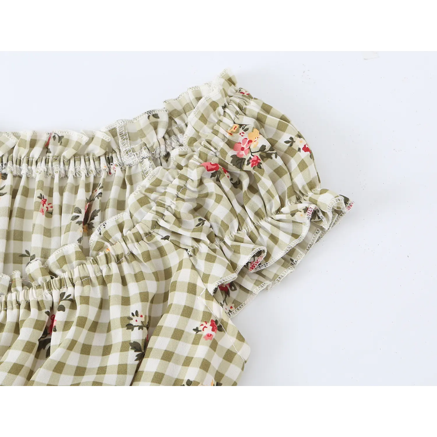macro detail of frilled ruffle cap sleeve elastic shirred edge olive green check pink rose sundress fabric