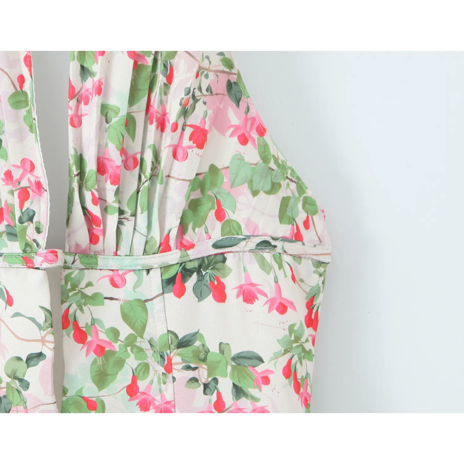 Upper torso partial shot, plunge deep V bust with side gathers, fitted underbust band, all-over fuchsia floral print