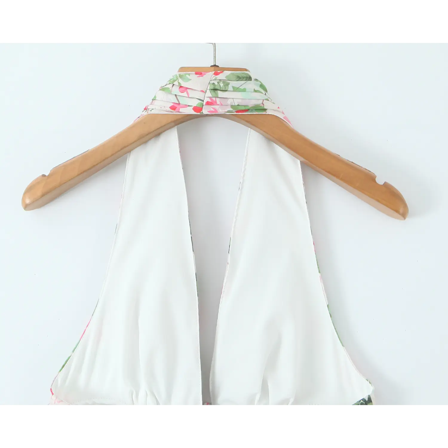 Back neck interior shot, solid white smooth lining fabric, folded halter band topstitch finish
