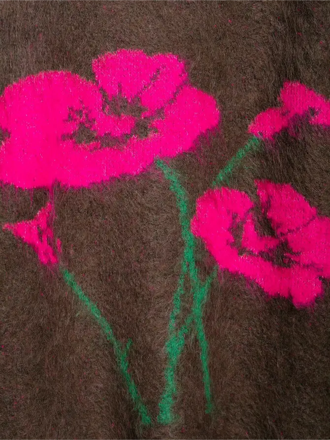 Close-up of neon pink poppy intarsia motif