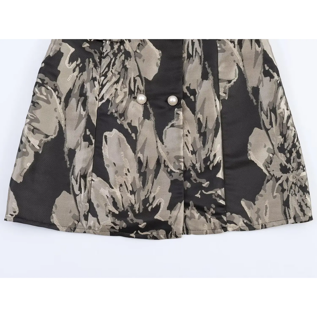 Partial view of A-line skirt hem for black grey floral jacquard mini dress, double-breasted pearl buttons and woven floral pattern