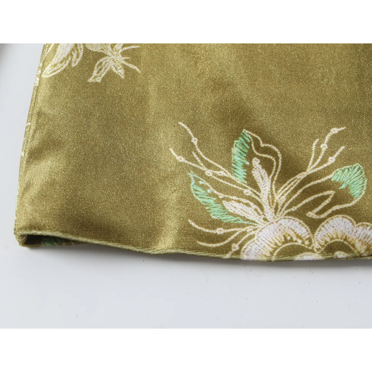 Close-up of blazer hem and floral motif