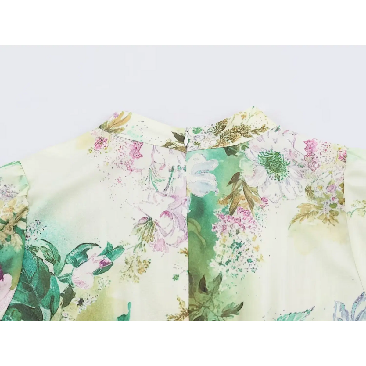 Close-up of metal zipper at back collar of floral print dress with gathered shoulder
