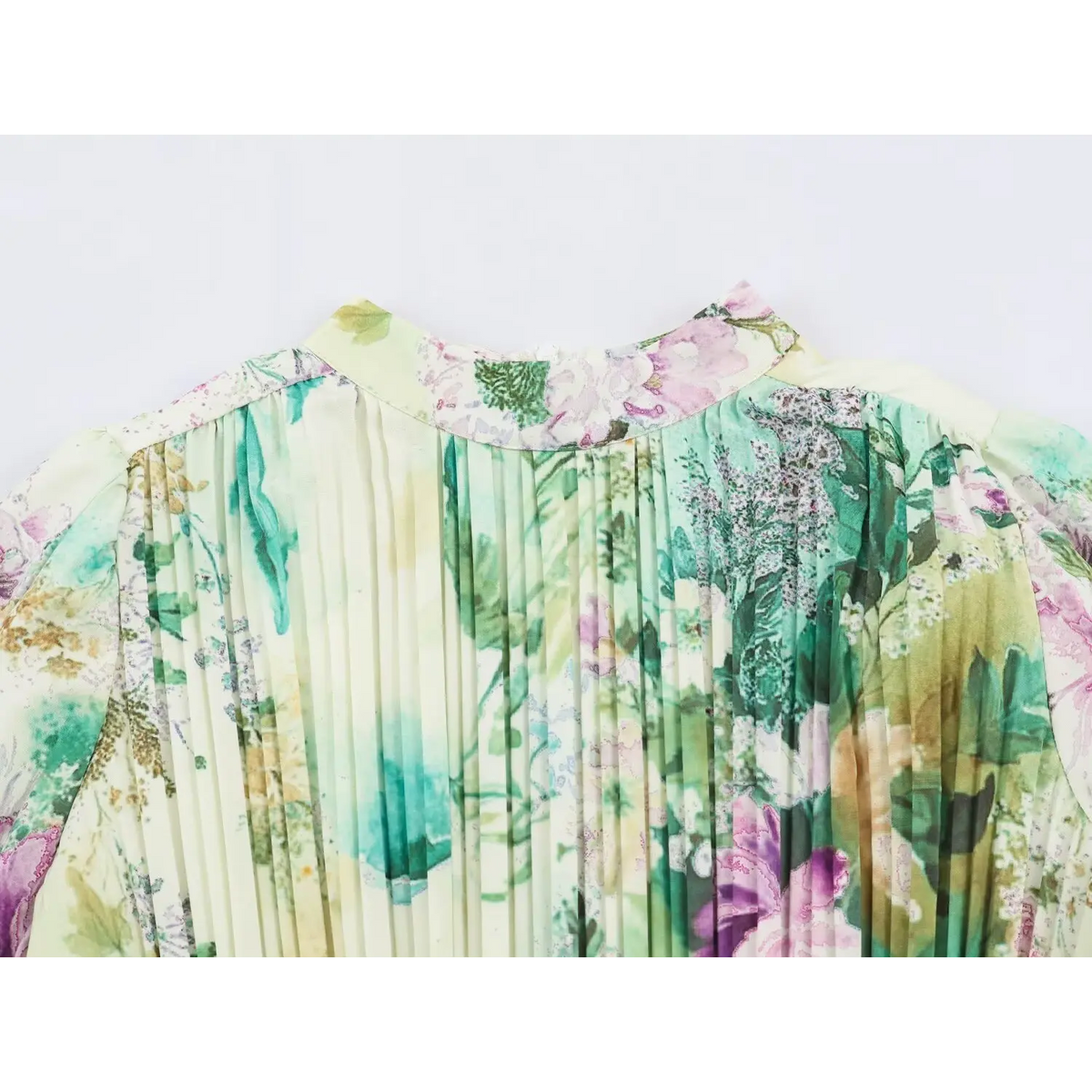 Close-up of stand collar and pleated shoulder on cream floral print dress