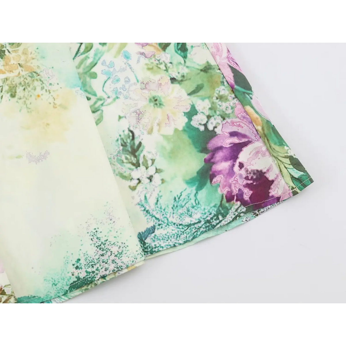 Close-up of floral print fabric with clean stitching and folded layers