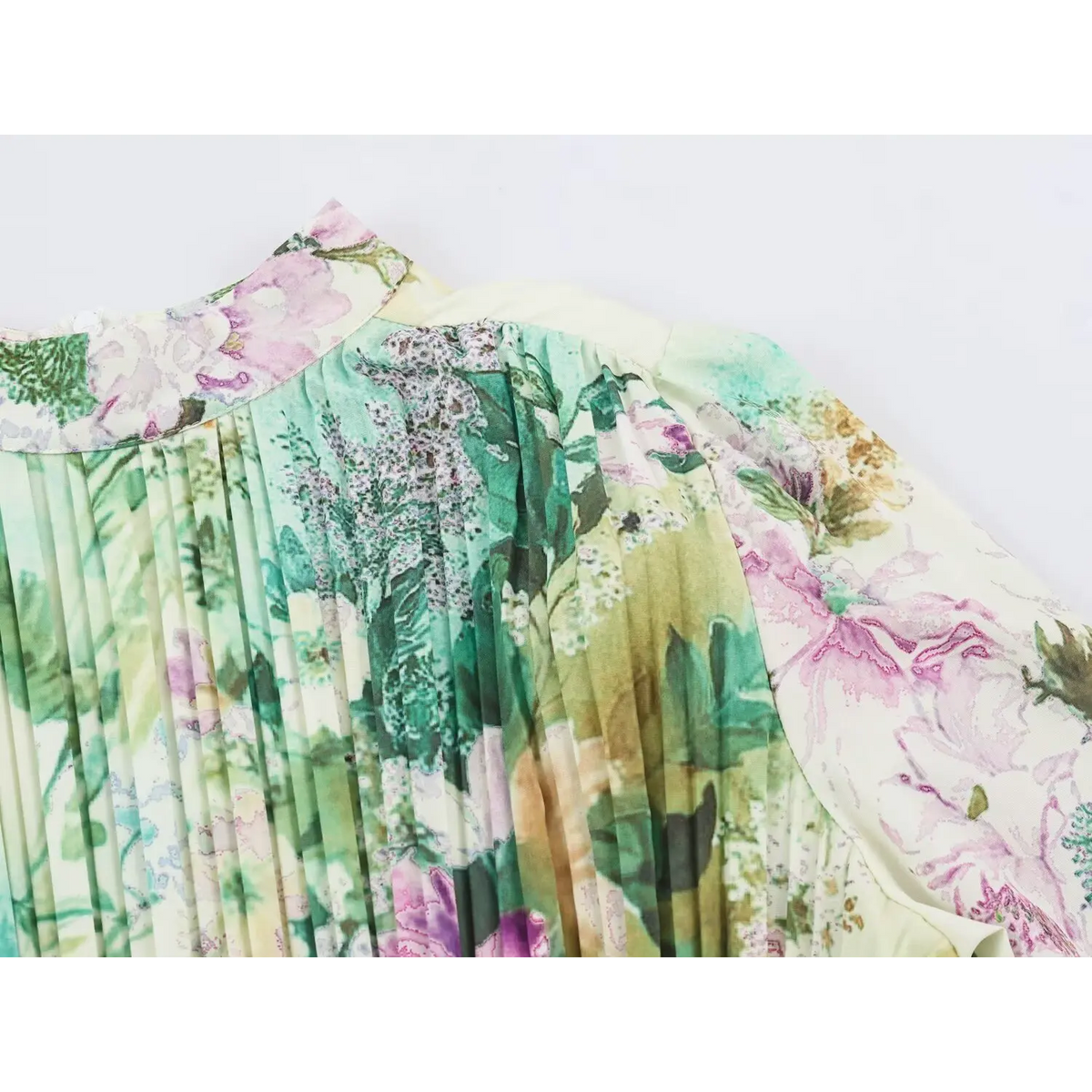 Close-up of finely pleated bodice with pink and purple watercolor flowers on maxi dress