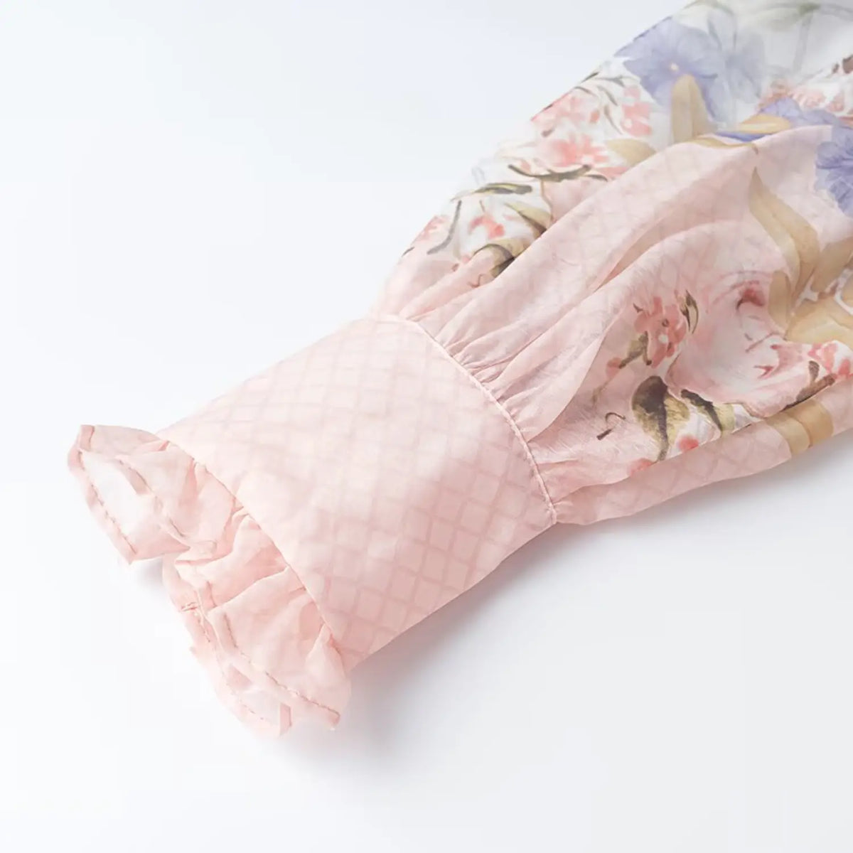 Close-up of balloon sleeve ruffle cuff on floral bird print chiffon maxi dress, sheer grid chiffon fabric