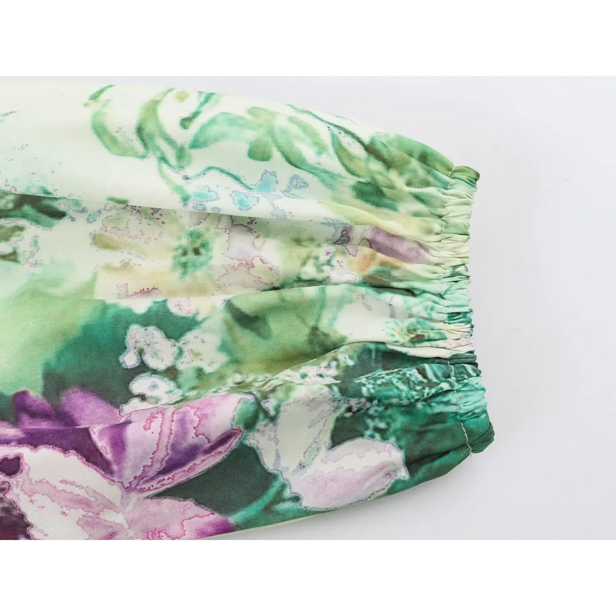 Close-up of elastic shirring and watercolor floral print fabric on sleeve