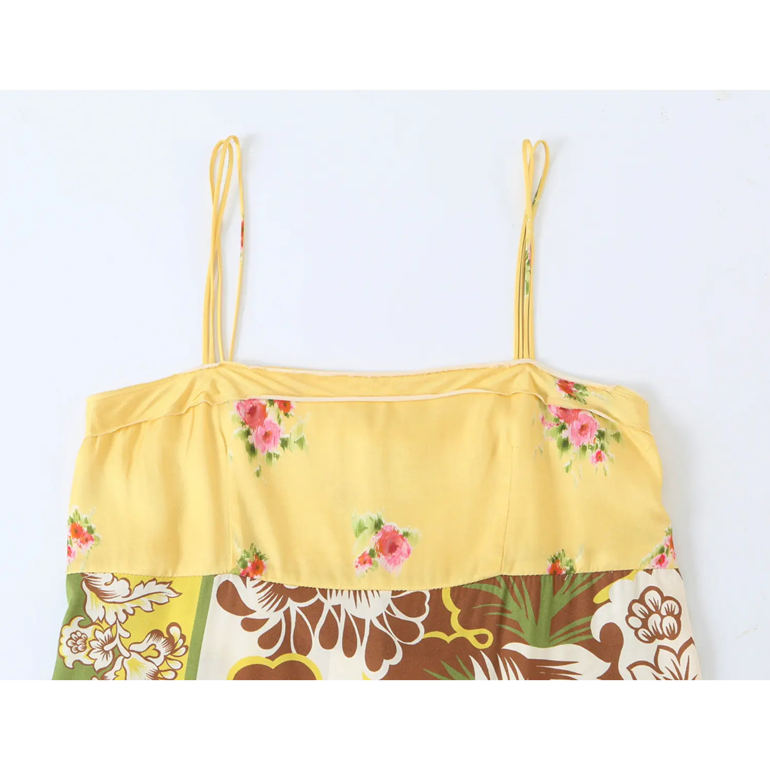 Close-up shot of square neck bodice and thin spaghetti straps on retro floral slip midi dress