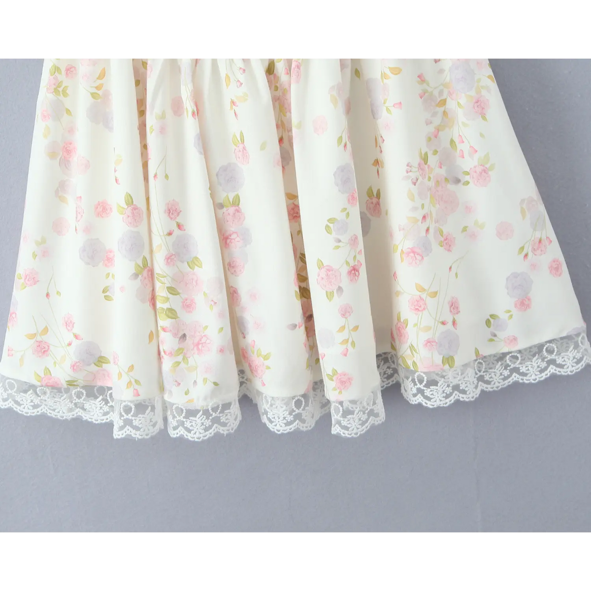 Close‑up of flowy skirt fabric, pink purple rose floral print, ruffled silhouette