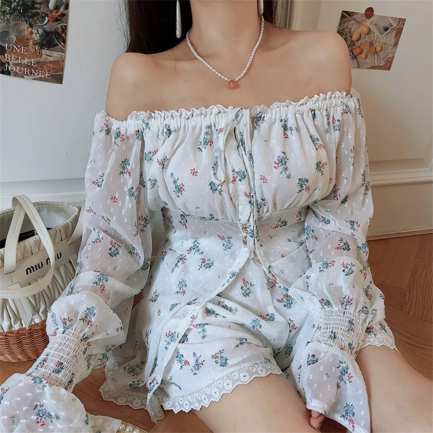 Close front torso model shot floral two piece set, bust drawstring tie detail, vertical metal button placket, smocked cuffed flared sleeve, swiss dot textured fabric