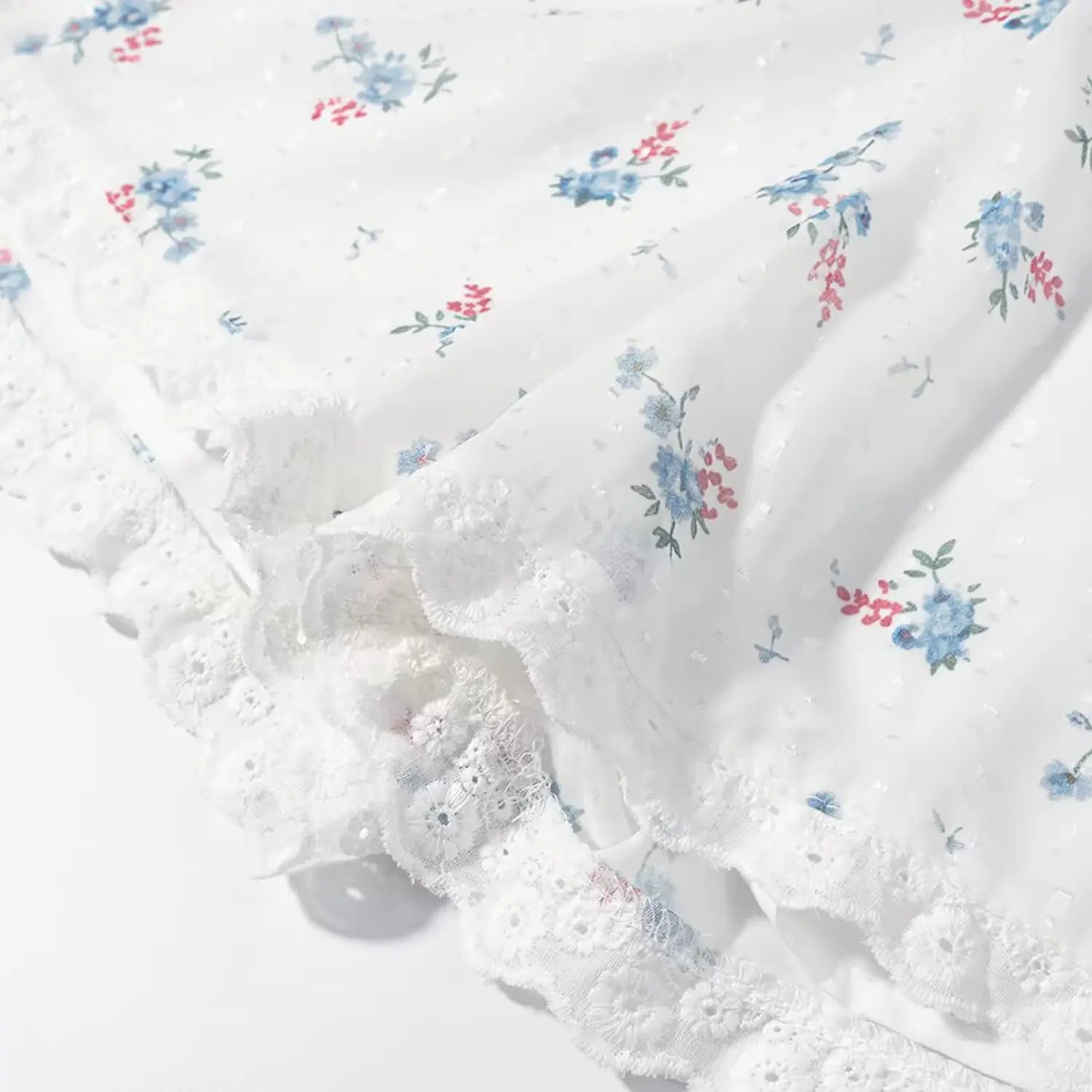 Macro texture double layered scalloped lace hem of floral shorts, layered fabric overlap detail, all-over blue red mini floral print