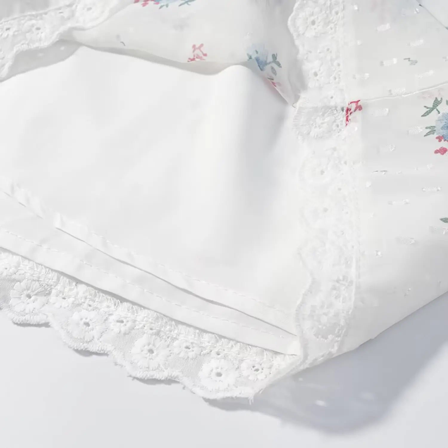 Inner lining closeup, matching solid white lining fabric, lace hem binding seam, loose A-line short silhouette inner structure